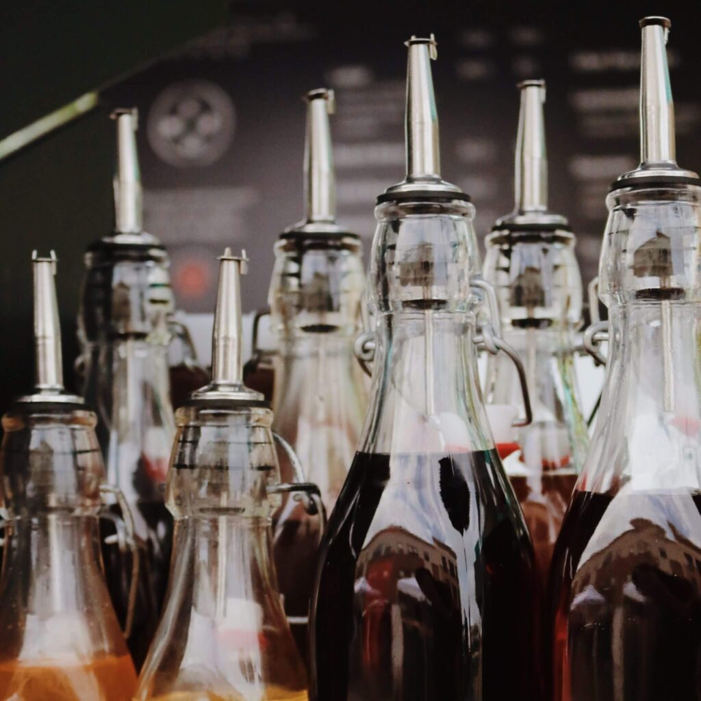 A selection of glass bottles with premium coffee syrups, perfect for customizing beverages at events.