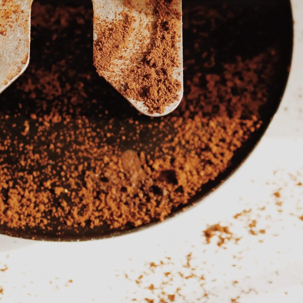 Close-up of freshly ground coffee, showcasing the rich texture and quality of the beans used in every brew